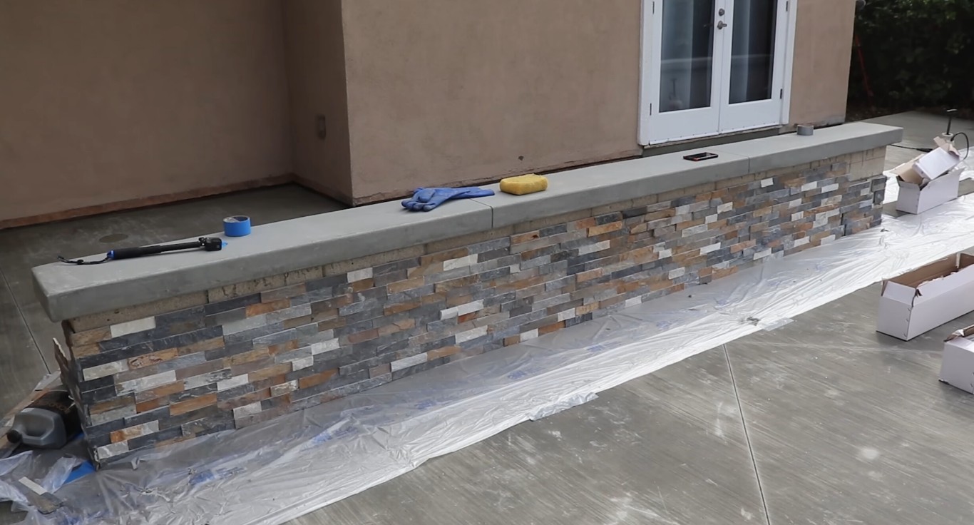 Professional masonry team installing ledgestone veneer in Brownsville, TX